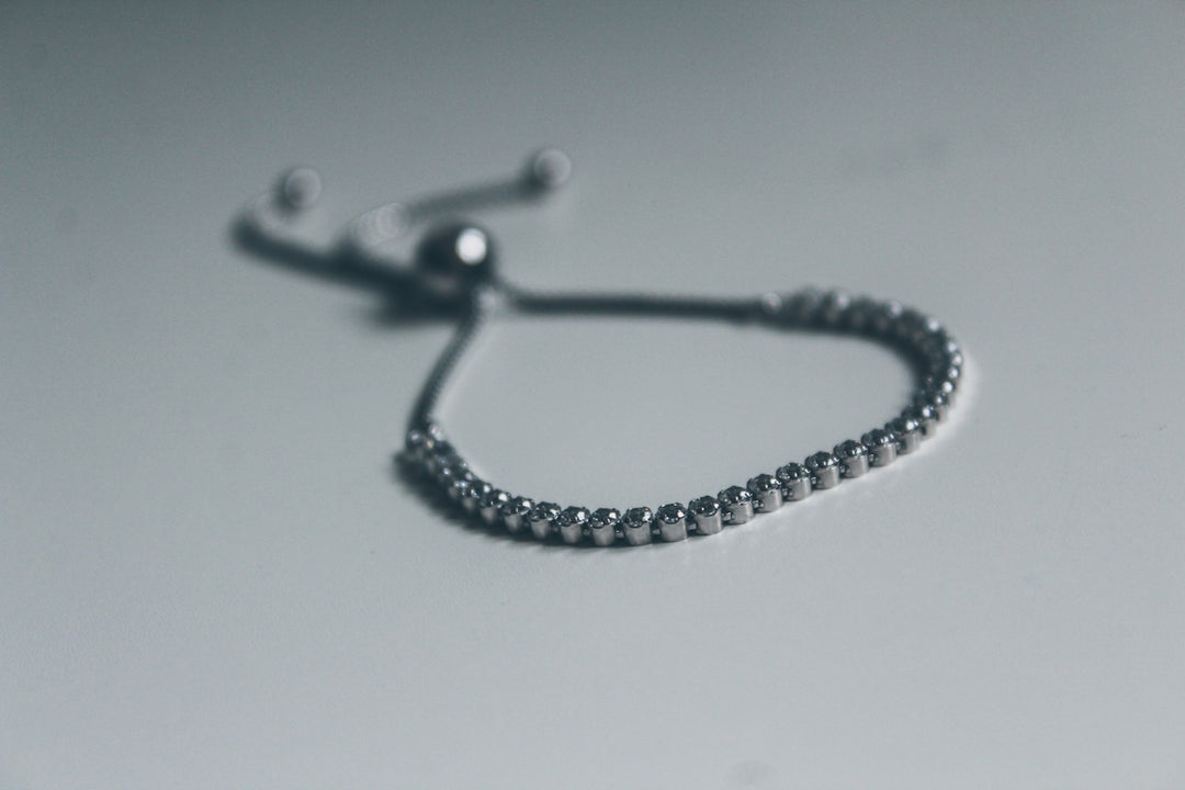 silver bracelet on white surface
