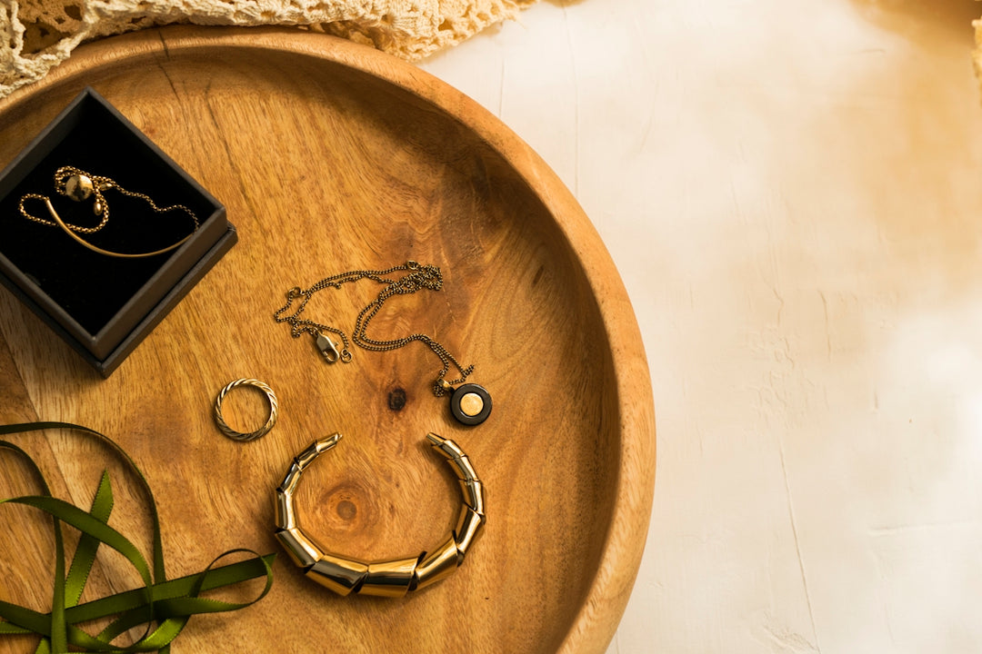 silver rings on brown wooden round tray