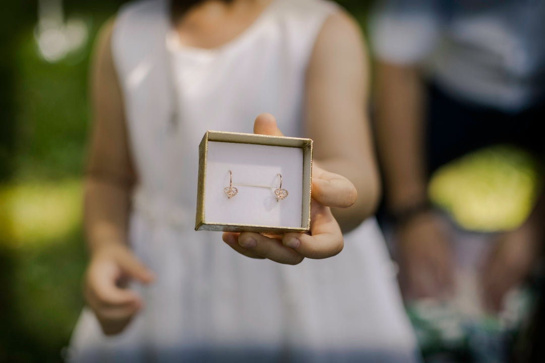 woman in white tank top holding gold photo frame
