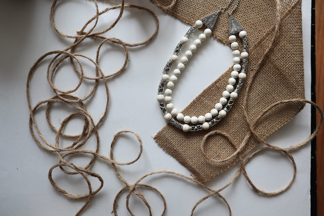 a couple of necklaces sitting on top of a table