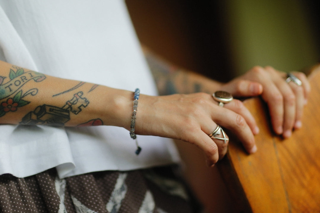 a woman with tattoos on her arm and arm