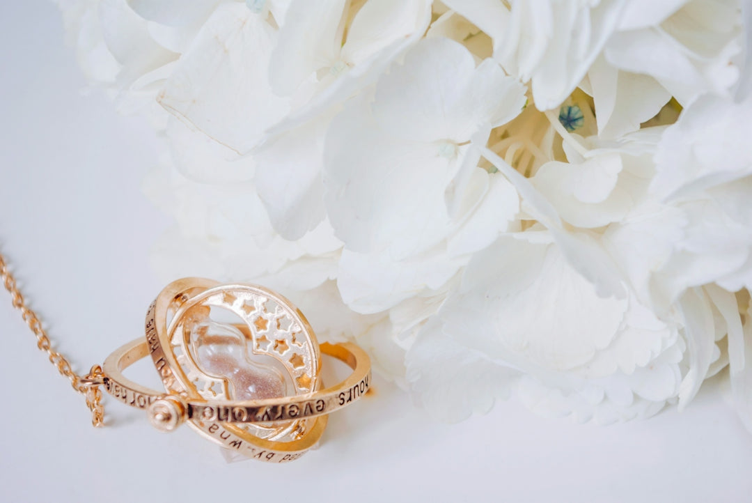 a close up of a flower and a necklace
