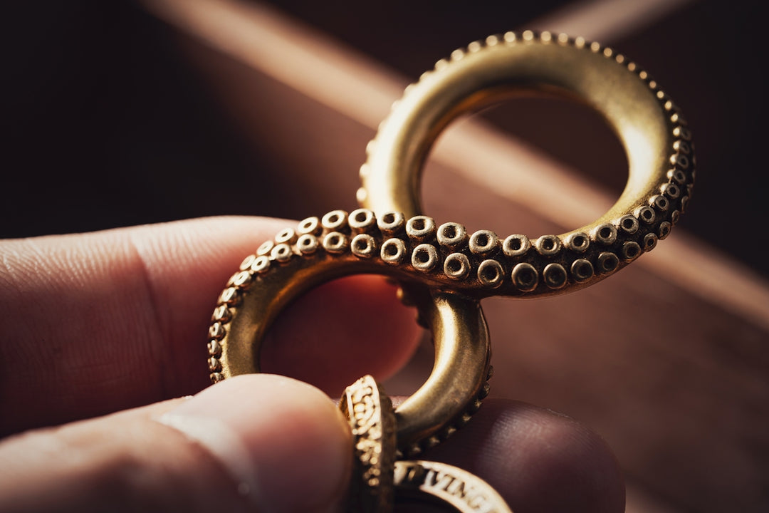 a person holding a gold ring in their hand