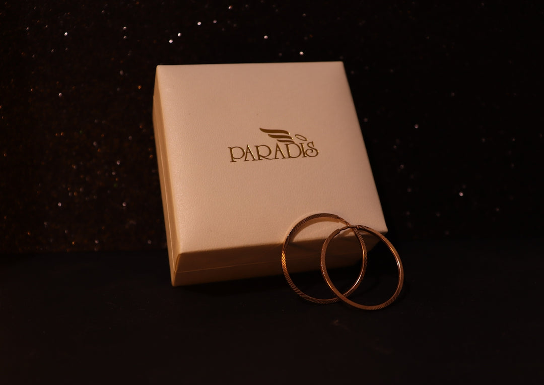 A white box with a pair of rings inside of it